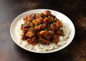 Chinese traditional cuisine sticky braised pork belly with rice on white plate